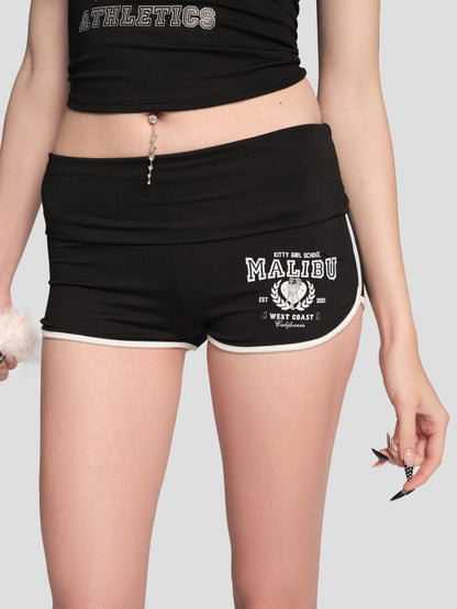 Black shorts with a white logo and text on a plain background