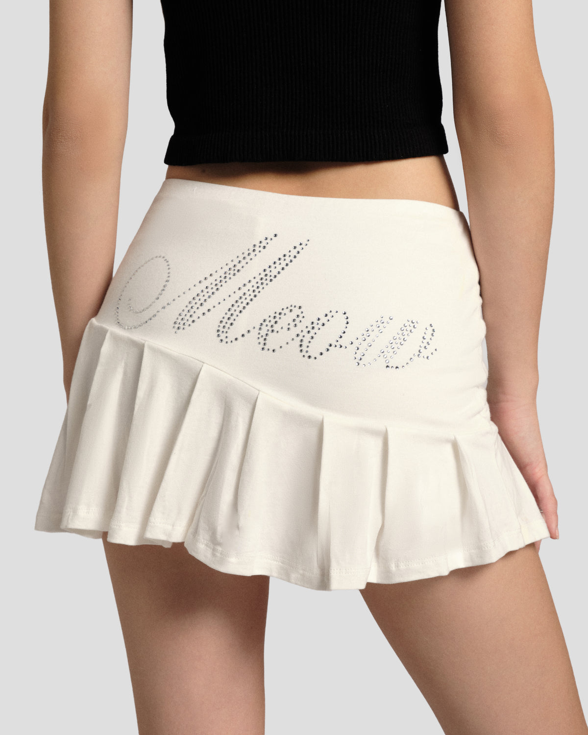 Feral Spell Knife Pleat Skirt, back close-up of the rhinestone Meow script